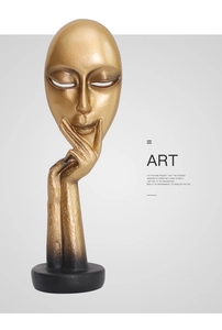 Close-up of abstract golden face sculpture with hand-on-chin pose and textured finish