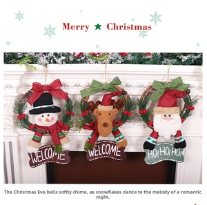 Detailed view of Christmas rattan wreaths with Santa, reindeer, and snowman dolls
