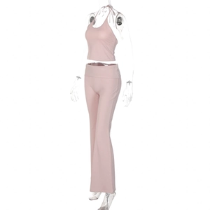 Detail view of pink halter crop top and high waist flared pants set on mannequin