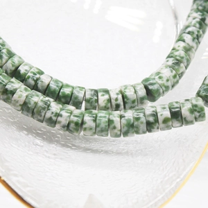 Macro detail of 6x3mm green natural stone abacus beads for DIY jewelry making