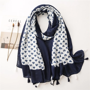 Detail of heart print cotton linen scarf featuring delicate blue and white fringe tassels