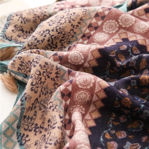 Close-up of bohemian floral print scarf with purple patterns and decorative fringes