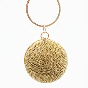 Elegant gold spherical evening clutch bag covered in sparkling rhinestones with metal handle