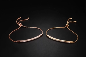 Close-up of rose gold adjustable slider bracelets with sparkling row of white zircons