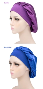 Detail view of purple and royal blue satin sleep caps with elastic wide bands