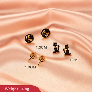Halloween earring set featuring black cat and orange lollipop studs on pink satin