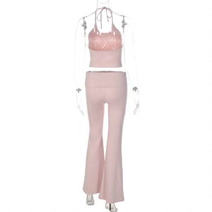 Back view of pink halter crop top and high waisted flare pants set on mannequin