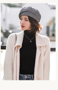 Chic autumn style showing a black and white houndstooth beret and a beige cardigan