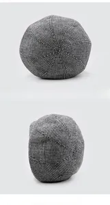 Detailed top and side view of classic black and white houndstooth knit beret hat