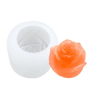 White silicone rose flower mold for DIY candles and ice balls with a finished orange rose