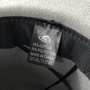 Detail of wool fedora hat lining with material tag showing 65% cotton and 35% polyester