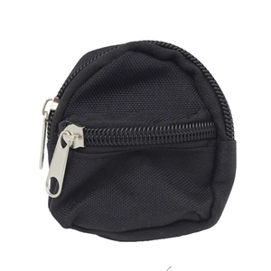 Close-up of a round black canvas coin purse with dual silver zippers on a white background