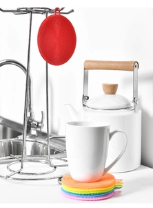 Rainbow-colored silicone dish brushes and heat-resistant pads in a modern kitchen setting
