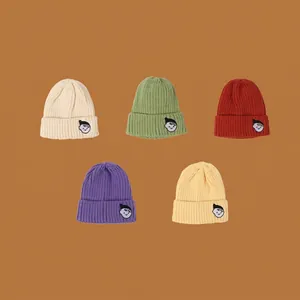 Set of five colorful knitted beanies for kids featuring cartoon embroidery patches