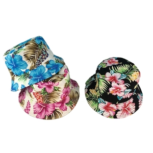 Detail of reversible bucket hats with tropical hibiscus prints in blue, pink, and black