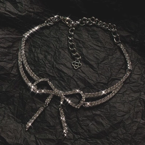 Elegant silver bow pendant necklace with sparkling rhinestones and delicate tassel charms
