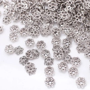 Macro shot of vintage silver flower bead caps for DIY jewelry and bracelet crafting