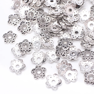 Close-up of silver hollow five-petal flower bead caps for DIY jewelry making