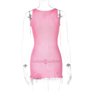 Detailed view of pink knitted sleeveless dress featuring dense fringe trim at the hemline