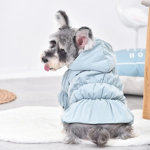 Light blue hooded pet winter coat shown on a dog in a cozy home setting
