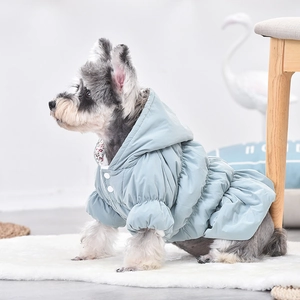 Detail view of floral lining and button closure on small dog winter puffer dress