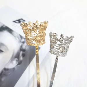 Detail of metal rhinestone tiara headband featuring hollow floral engraved pattern