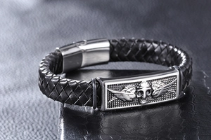 Macro side view of braided leather bracelet with skull and wings stainless steel engraving