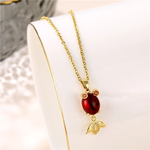 Gold titanium steel goldfish necklace with red garnet stone and micro-pave zircon pendant