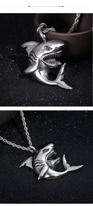 Detail of vintage silver shark pendant with intricate teeth carving on a twisted chain