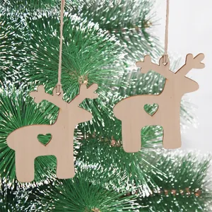 Christmas reindeer wood ornaments with heart cutout hanging on snowy pine branch