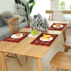 Christmas red and black buffalo plaid placemat set on wooden table for dining decor