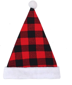 Detail of red and black buffalo plaid Santa hat with white plush trim and fuzzy pom pom