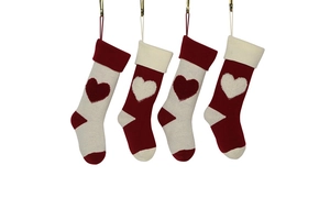 Detailed knit Christmas stockings with 3D heart patterns hanging on gold clips