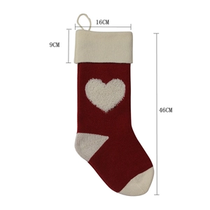 Detailed size guide for knitted red Christmas stockings with white 3D heart patterns