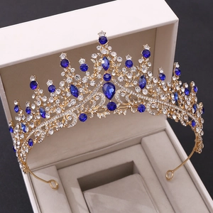 Détails d'une couronne de mariage dorée ornée de strass bleu royal et de cristaux clairs