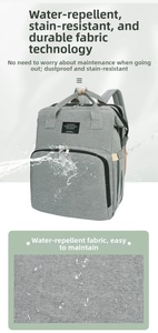 Water-resistant detail of grey multifunctional diaper backpack with foldable travel bed