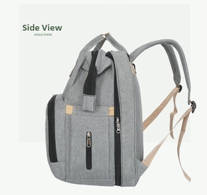 Side view detail of a large capacity grey foldable travel diaper backpack with zip compartments
