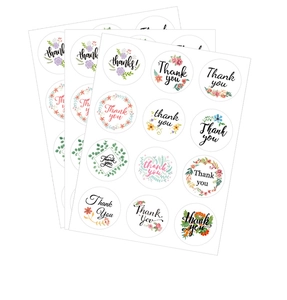 Detail of round Thank You stickers with colorful floral patterns for gift packaging