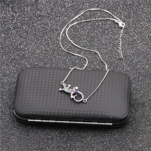 Micro-set zircon gecko pendant necklace with colorful gems on a black textured box
