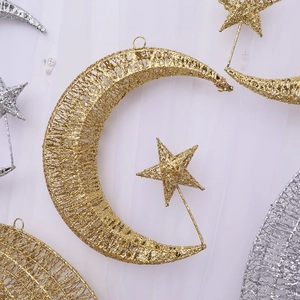 Sparkling gold and silver iron star and moon Christmas ornaments for festive window display