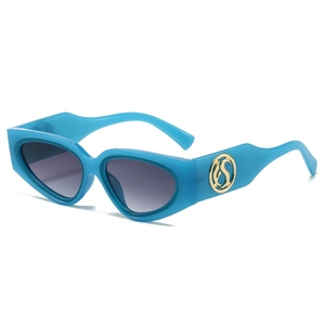 Blue cat eye sunglasses with thick frames and golden logo detail on the side temples