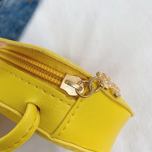 Mini yellow crossbody bag for girls with flower petal zipper detail and leather texture