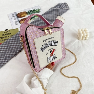 Close-up of pink sequined gas can bag with chain strap and Bad Bitch Fuel embroidery
