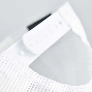 Detail of adjustable snapback closure and breathable mesh texture on white ponytail cap