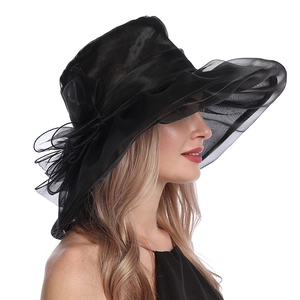 Detail of elegant black organza sun hat with wide wavy brim and large floral decoration