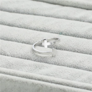 Minimalist double cross open ring in silver finish displayed on grey velvet jewelry box