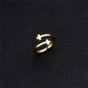 Macro shot of gold double cross ring featuring an adjustable open band on black leather