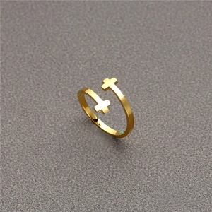 Fashionable golden stainless steel open ring with double cross design on textured background