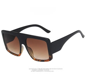 Detailed front view of oversized square sunglasses with black and leopard print frames