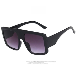 Front view of oversized square flat top sunglasses in bright black with gradient grey lenses